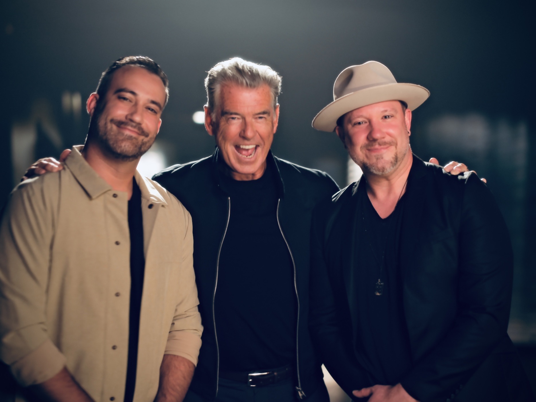 Kieran and Brendan Murphy on set with Pierce Brosnan